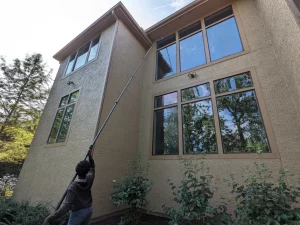 Using water fed pole to clean a window