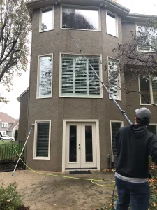 Cleaning windows with water fed pole