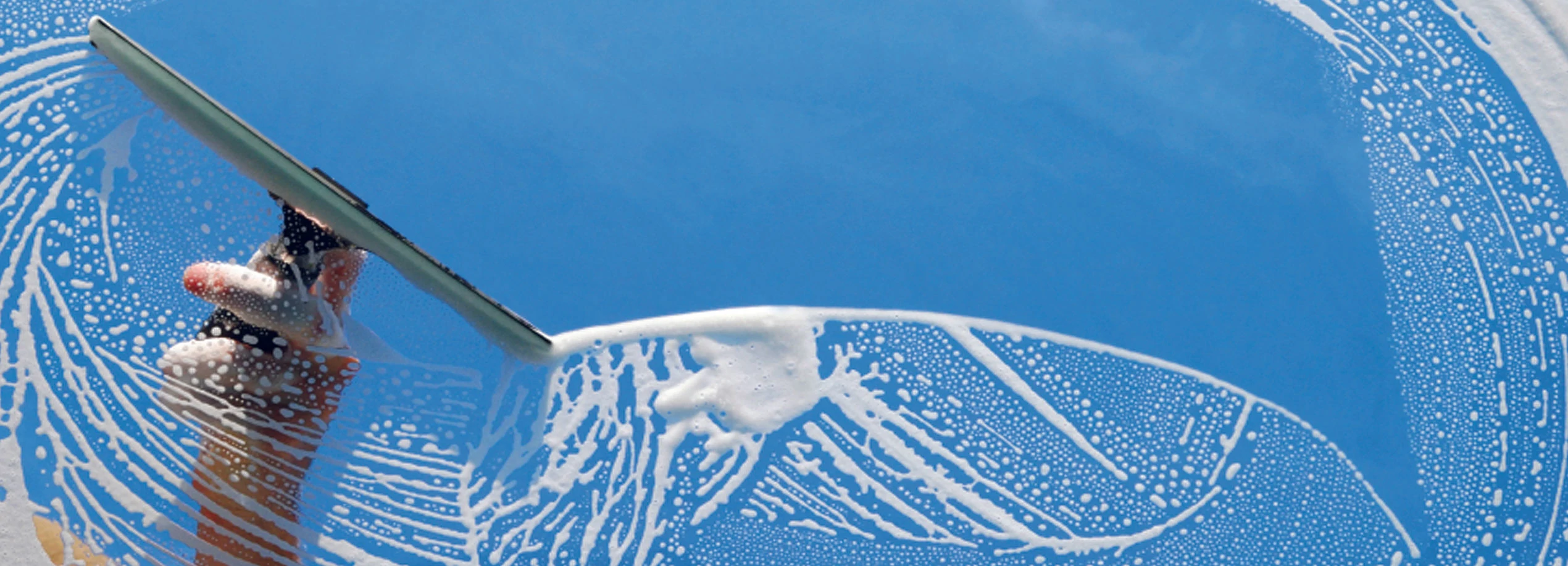 Squeegee on soapy glass